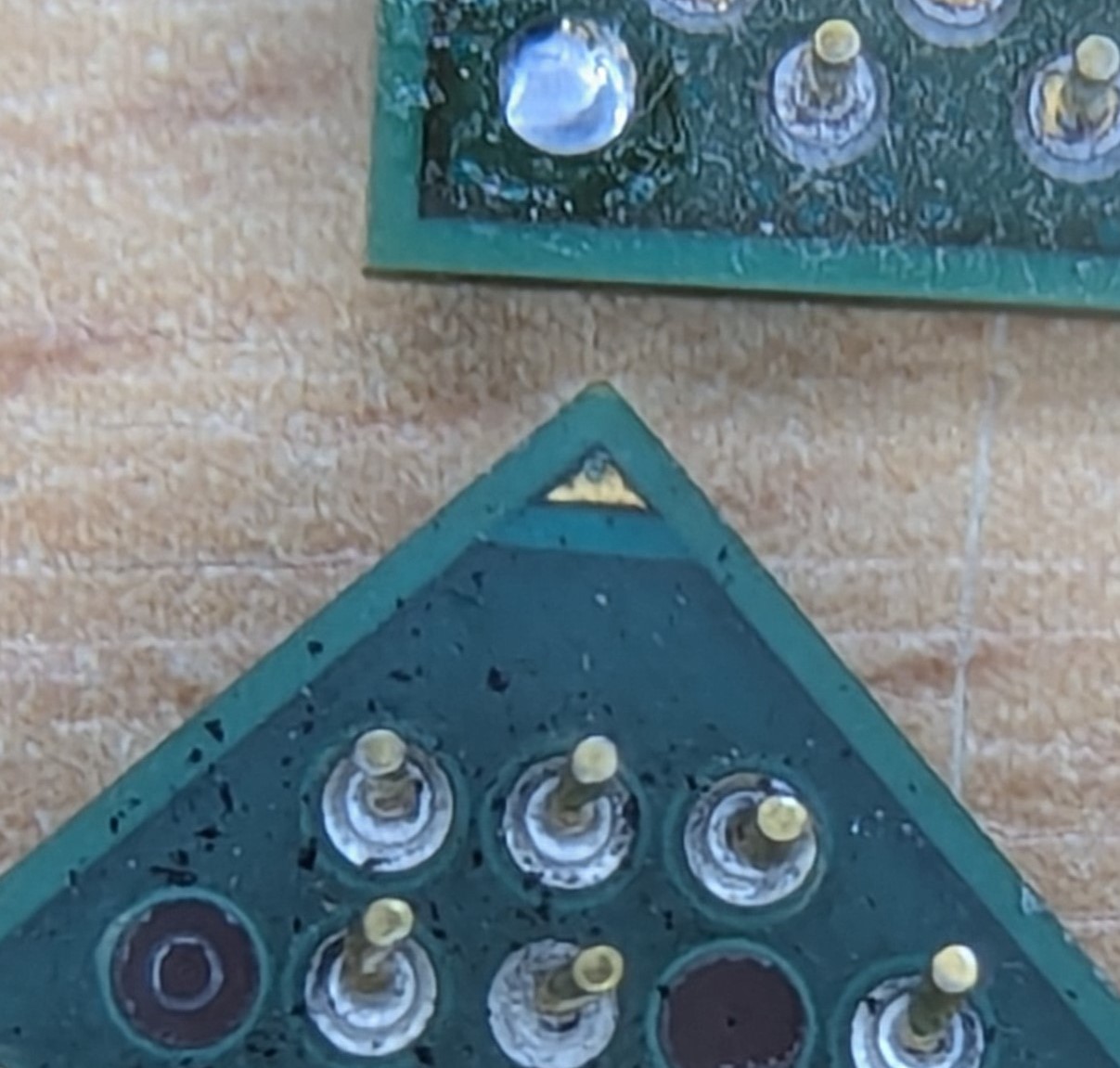 Pins with missing pads (bottom) and cleanly removed pin (top)