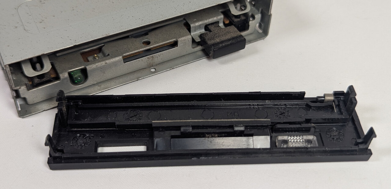 Bezel removed with the flap spring attached