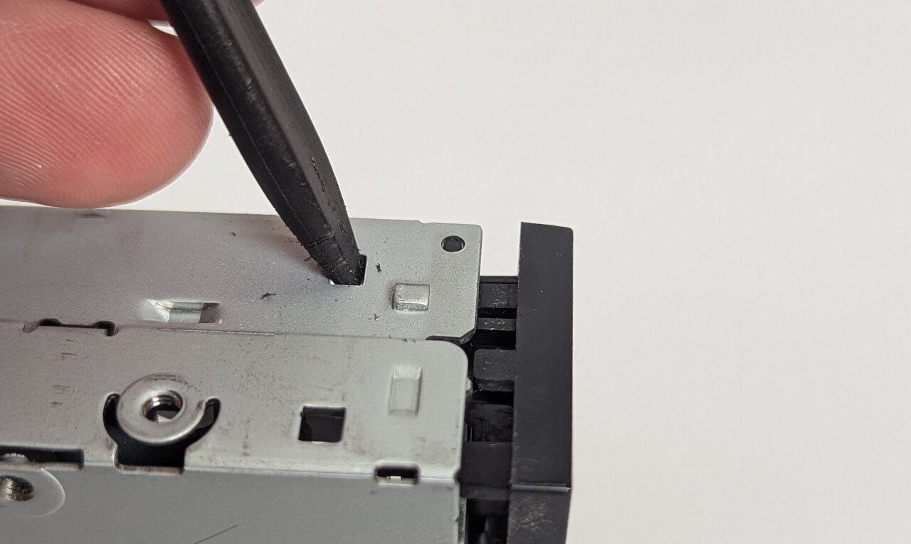 Releasing the bezel tabs with a spudger